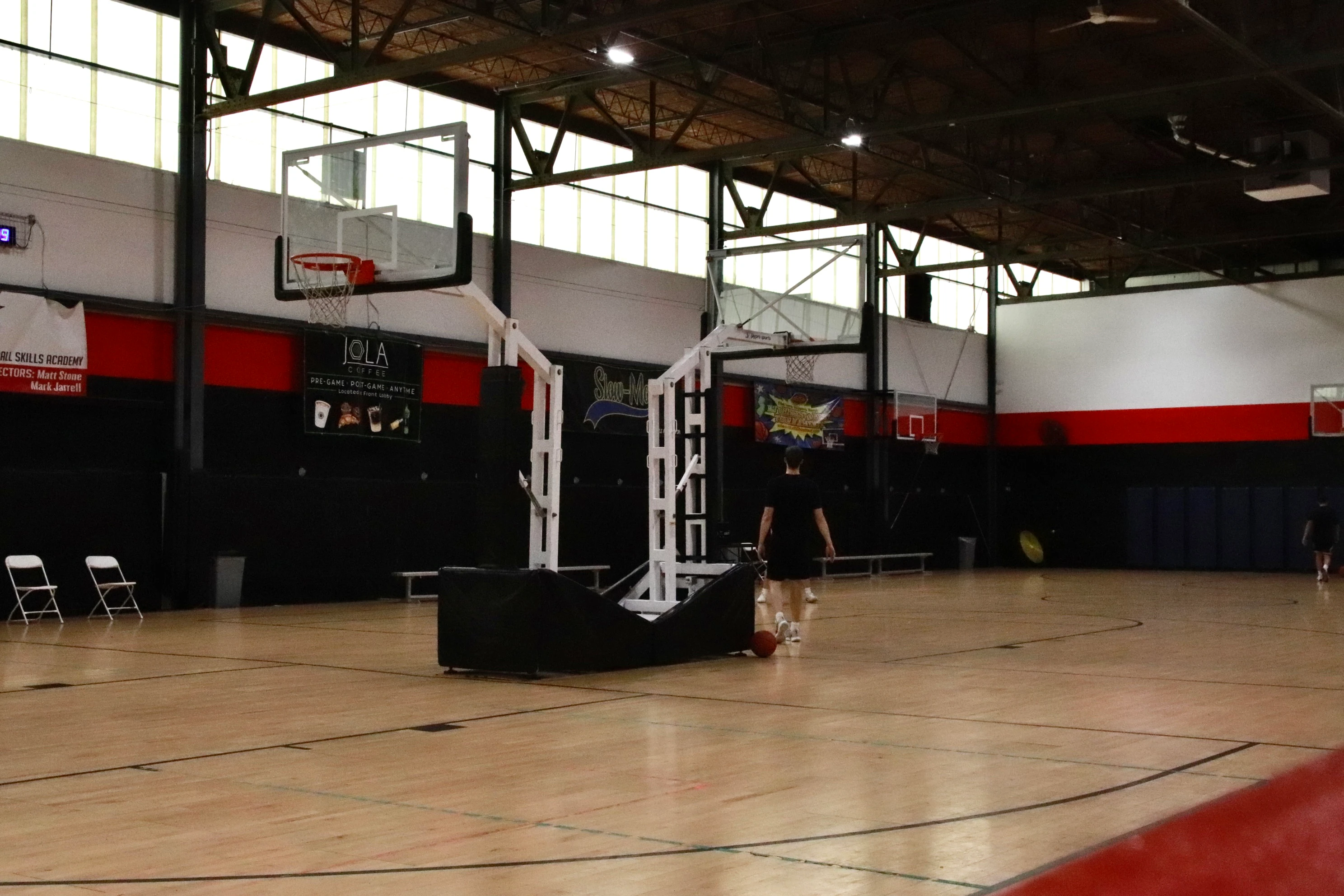 Basketball court under the skylights with a player shooting at XCEL Sports & Fitness in Fairfield, NJ
