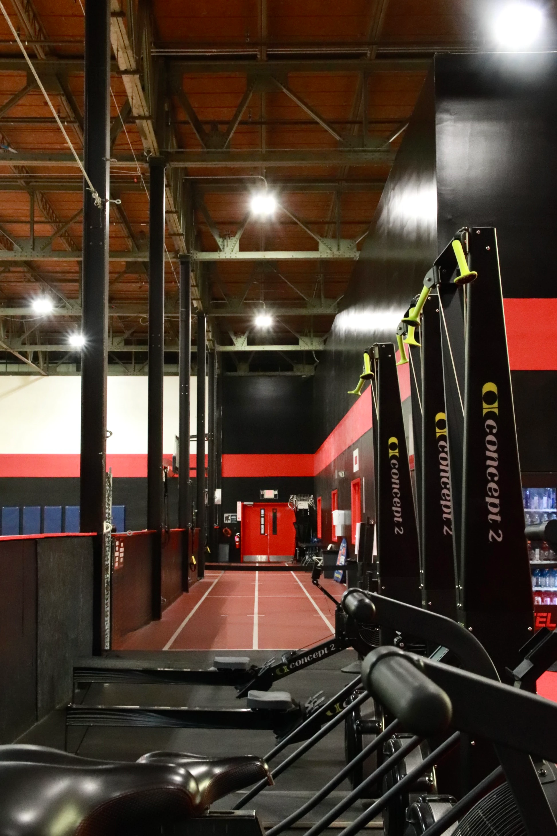 Concept2 SkiErgs beside the sprint track lanes for HYROX training at XCEL Sports & Fitness in Fairfield, NJ