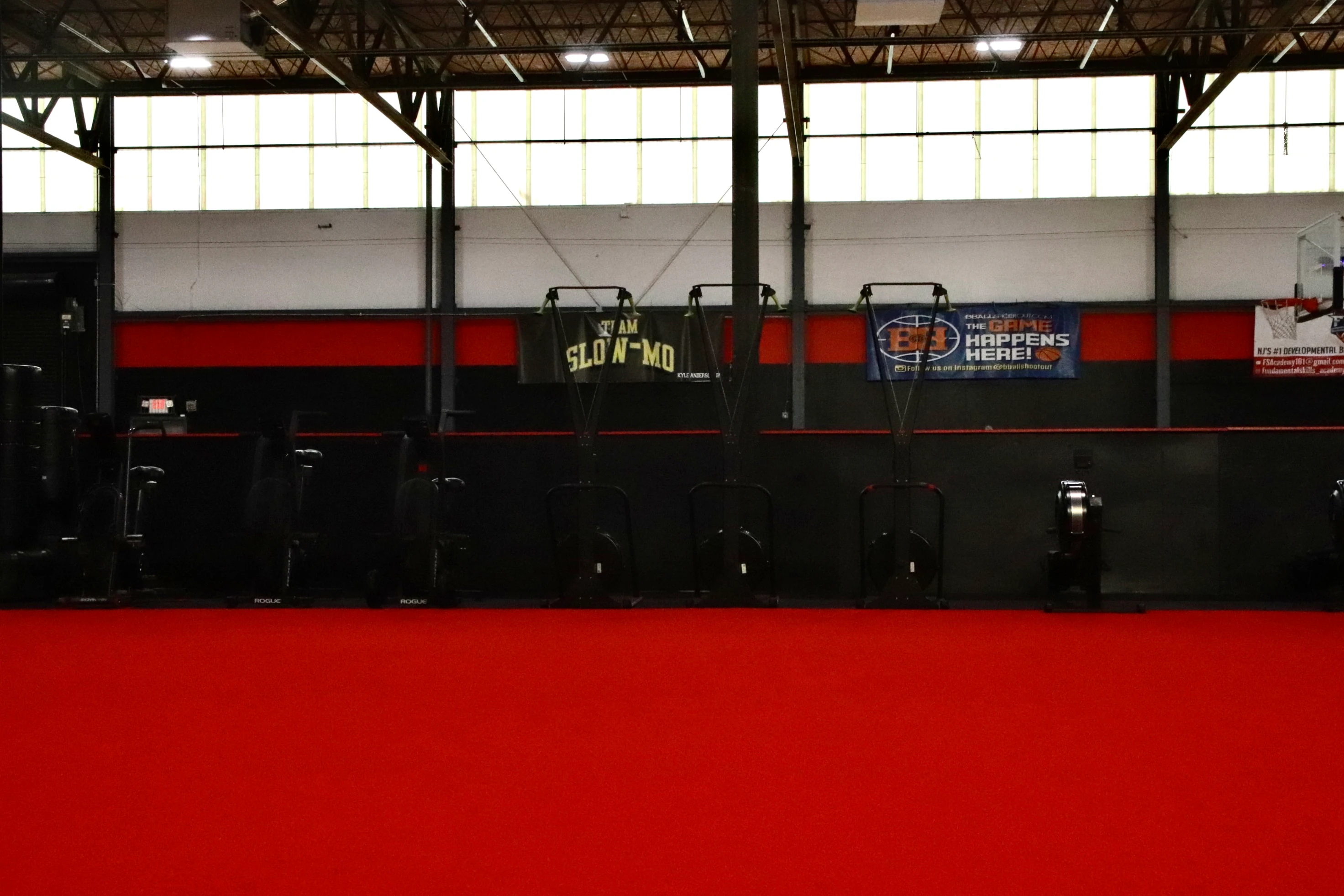 Red indoor turf with Concept2 SkiErgs along the wall at XCEL Sports & Fitness in Fairfield, NJ