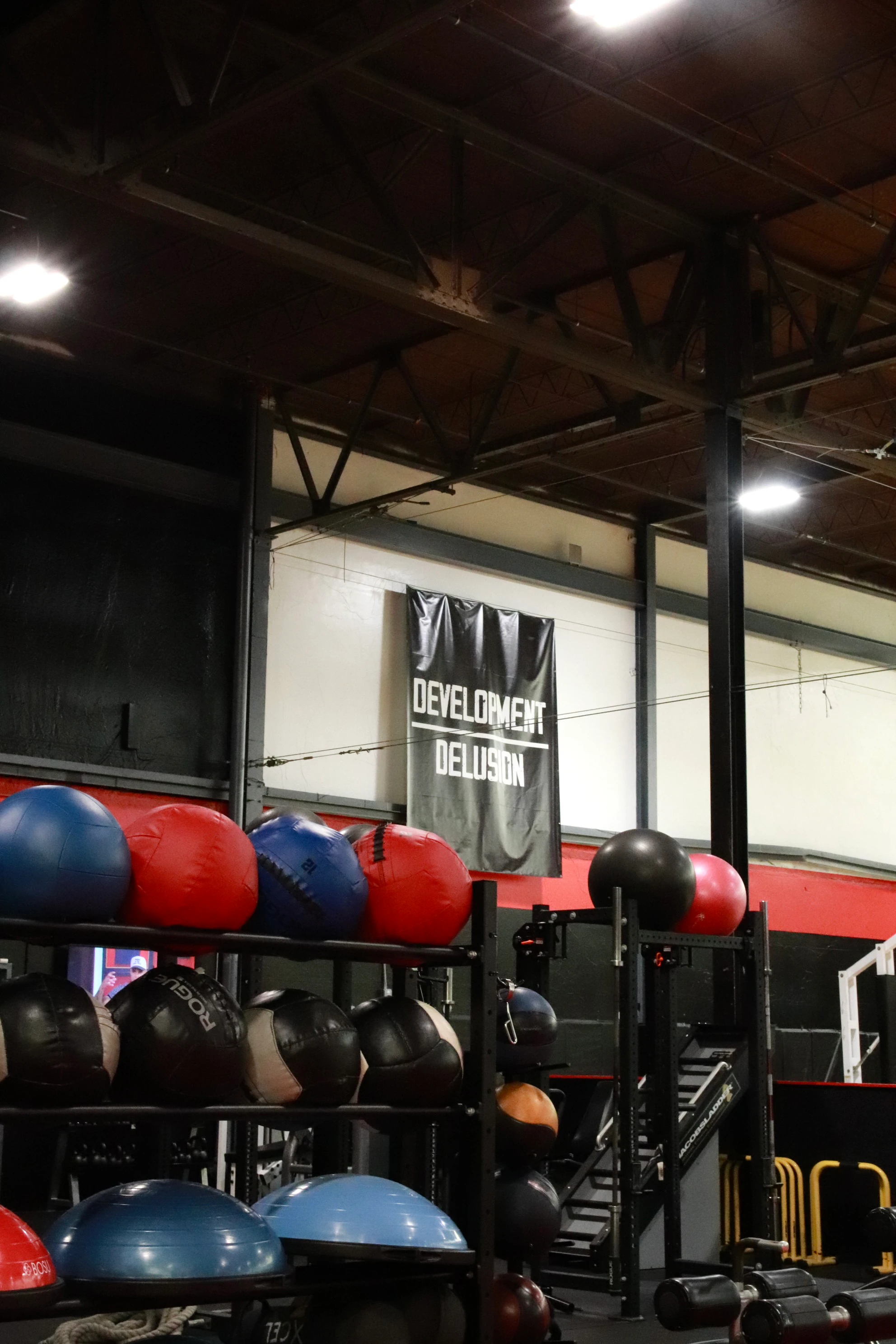 Medicine balls and BOSU balls under the Development Over Delusion banner at XCEL in Fairfield, NJ