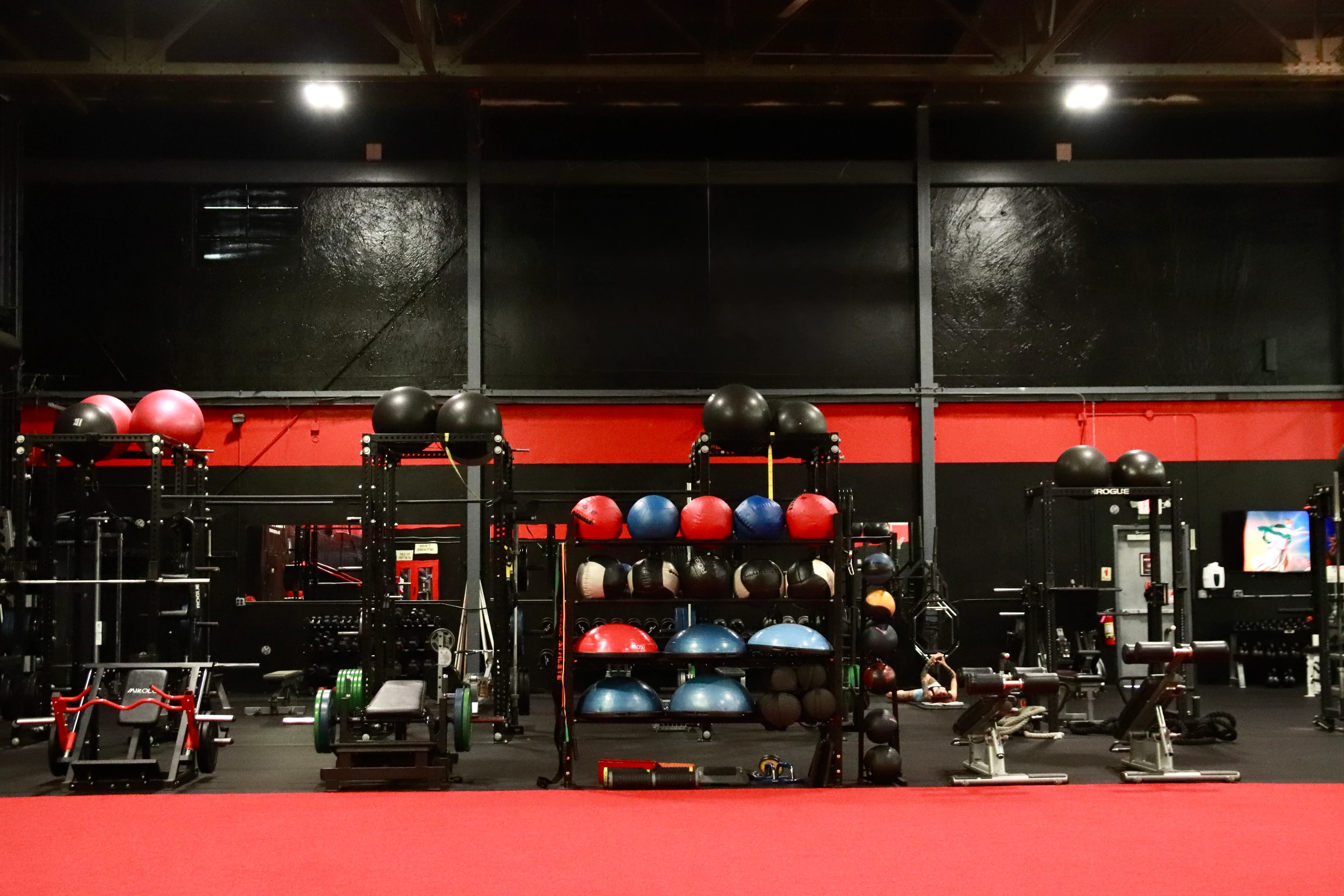 Medicine balls, stability balls and squat rigs on the functional training turf at XCEL in Fairfield, NJ