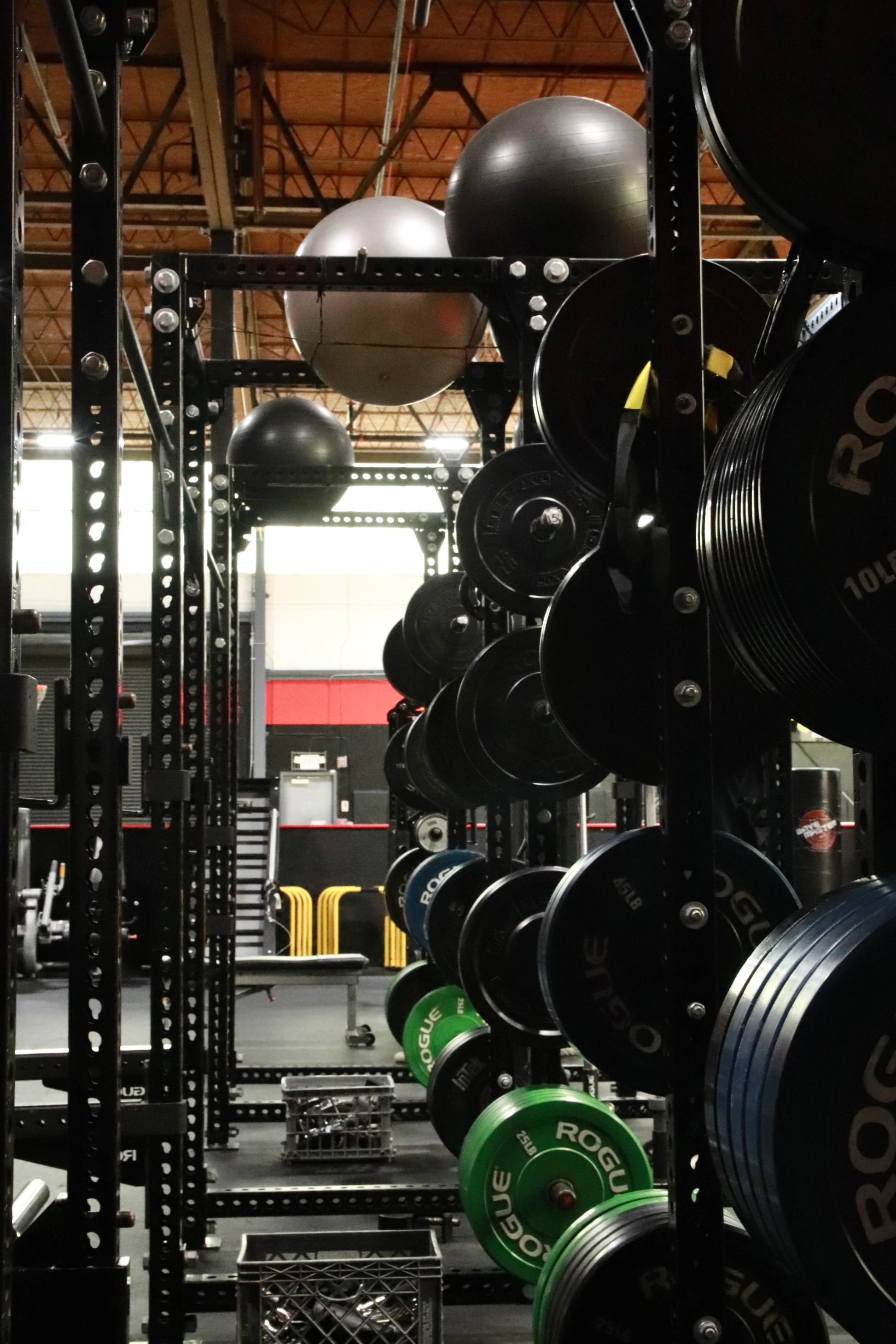 Rogue plate storage on a squat rig in the performance area at XCEL Sports & Fitness in Fairfield, NJ