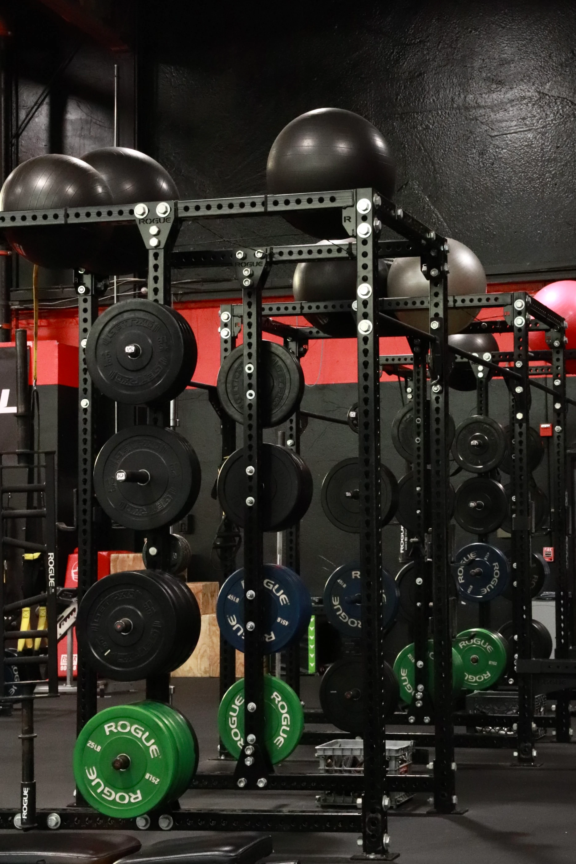 Rogue rig loaded with bumper plates and stability balls at XCEL Sports & Fitness in Fairfield, NJ