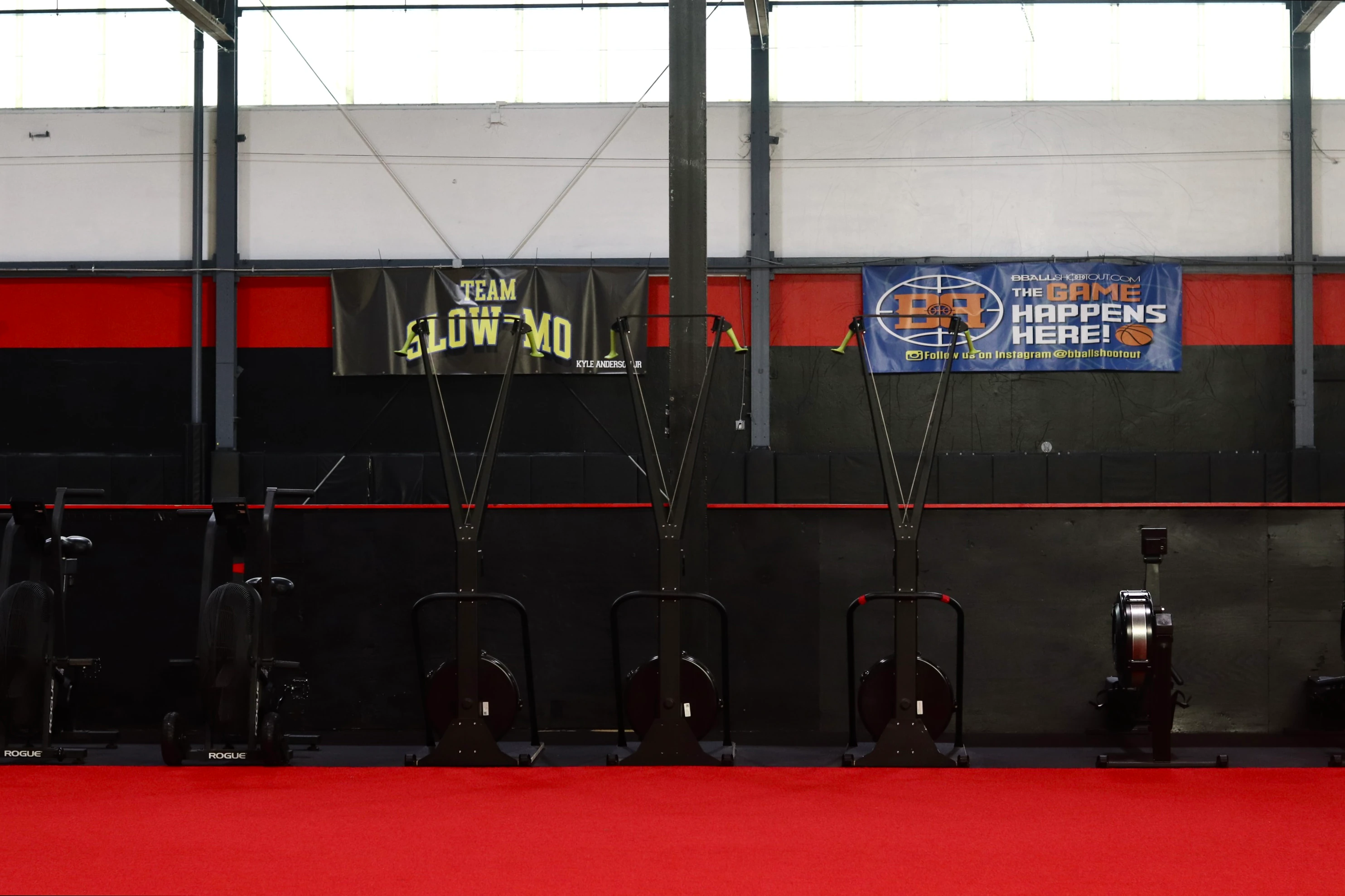 Concept2 SkiErgs on the red turf under youth team banners at XCEL Sports & Fitness in Fairfield, NJ