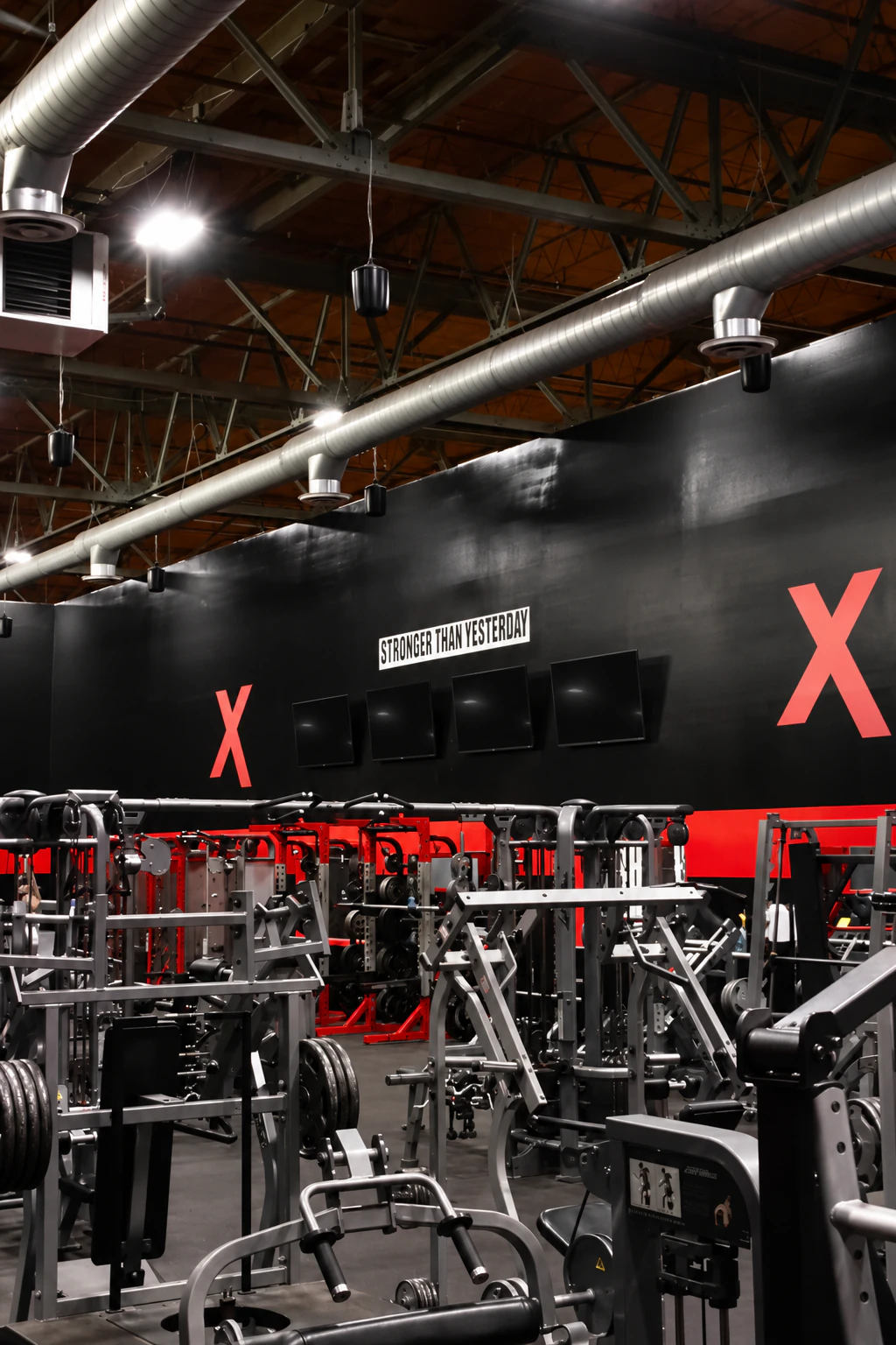 Overview of the strength floor, red X wall and Stronger Than Yesterday sign at XCEL Sports & Fitness, Fairfield, NJ